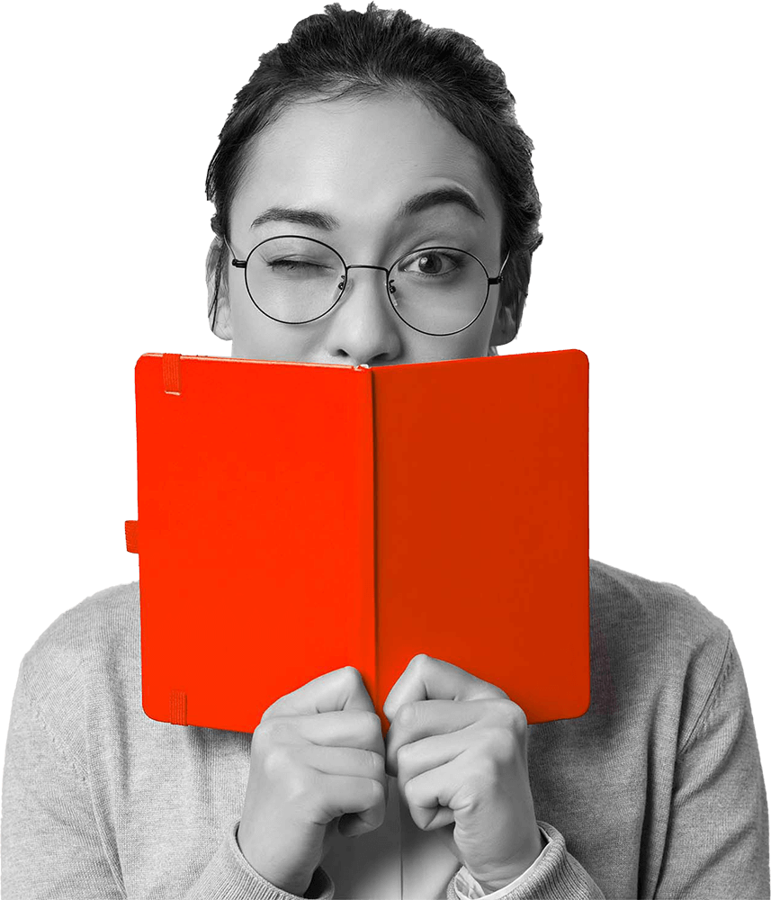 Woman in glasses peering over an open red notepad, representative of iTemi Media creative media agency, obstructing part of her face.