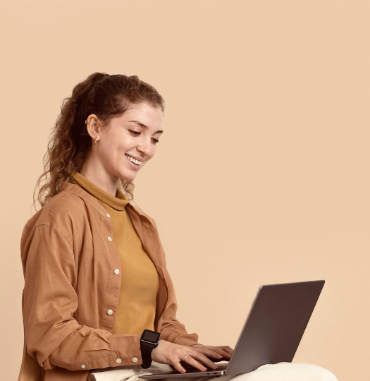 young tech lady sat on a chair, working on branding project for the creative agency from laptop