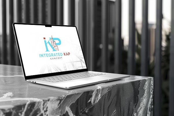 A laptop displaying the logo for Integrated Kap Concept, featuring stylized letters and a building icon, sits on a marble table against a blurred office background, showcasing the Integrated Kap Concept brand identity. Designed by our creative agency