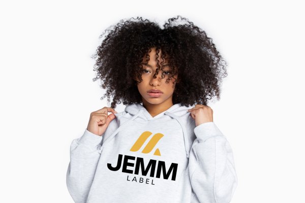 A young woman with curly hair wearing a white hoodie with the words "JEMM LABEL" printed on it, designed by our creative agency.