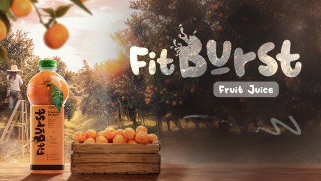 The advertising creative and branding we designed for FitBurst Fruit Juice, showing a bottle of orange juice in a sunny, fresh orange grove.